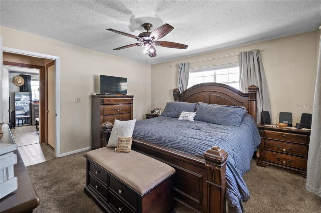 7422 County Road 231 Lake Butler, FL 32054 - Photo 27 of 57 a bedroom with a bed and a chandelier