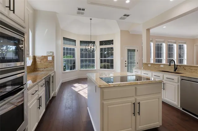 a spacious bathroom with a tub sink and mirror