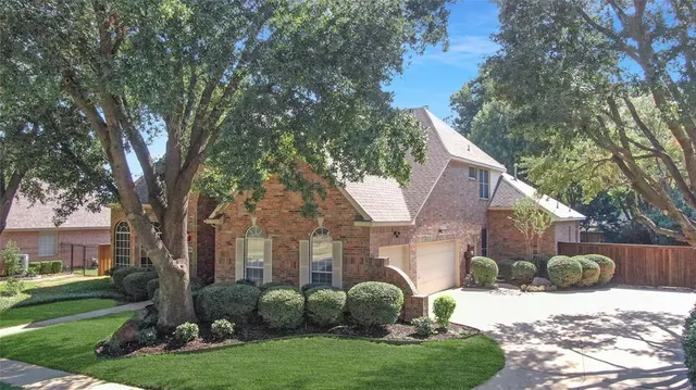 a view of a house with a yard and tree