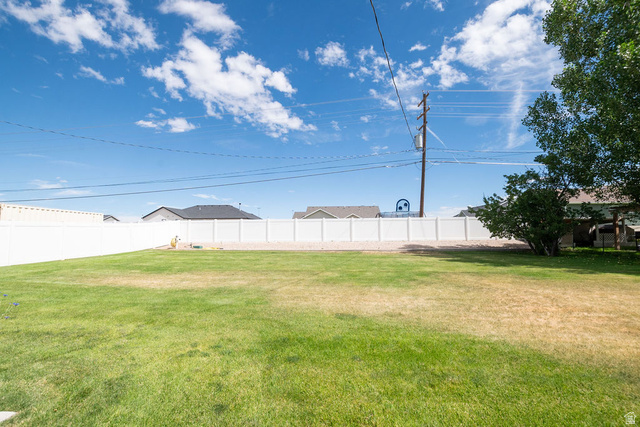 855 East 300 N Street Beaver, UT 84713 - Photo 11 of 44 Expansive green lawn fully enclosed by a white privacy fence