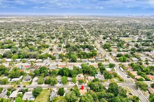 an aerial view of residential houses with city and outdoor space