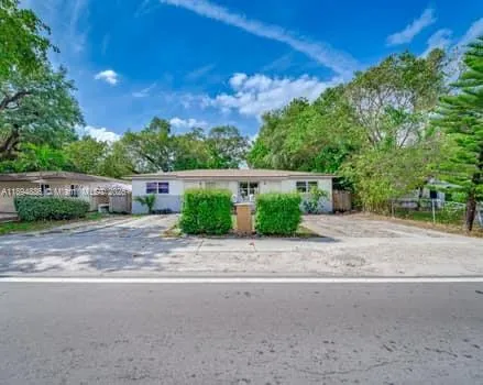 a view of a street with a house in the background