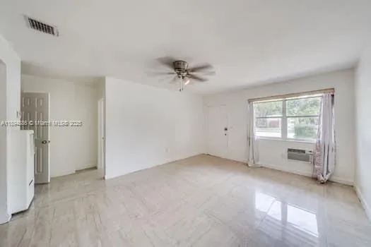 an empty room with closet and windows