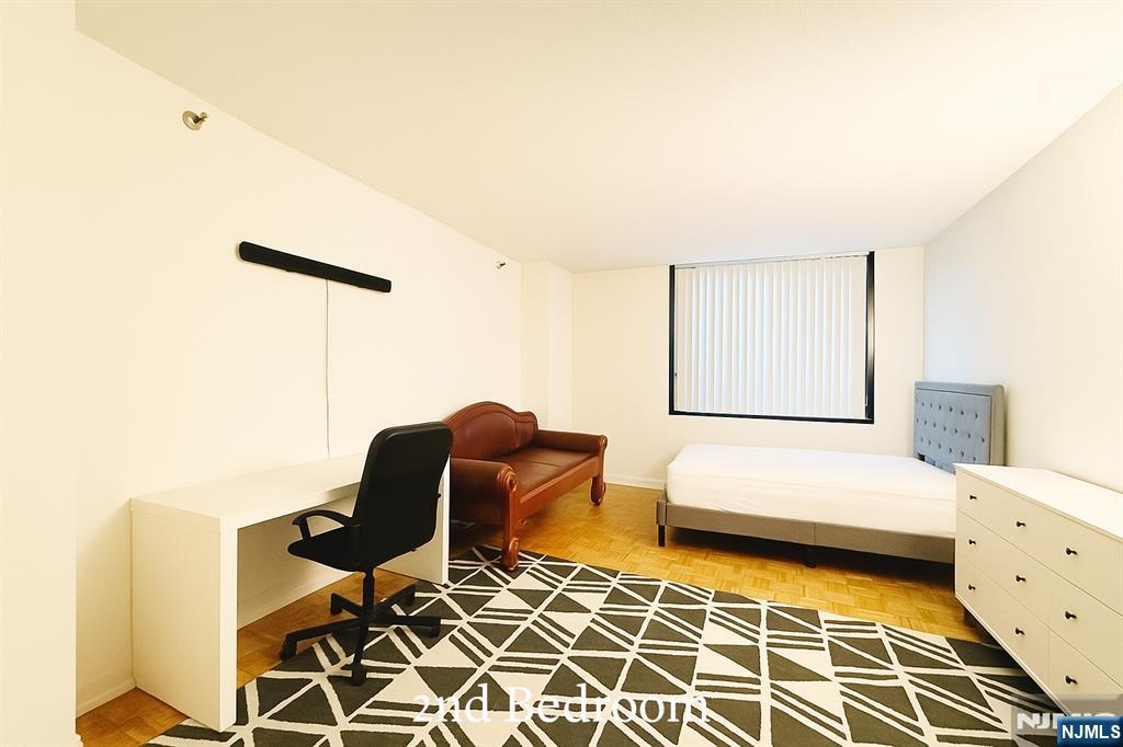 1265 15th Street, Unit 1A Fort Lee, NJ 07024 - Photo 10 of 14 a bedroom with furniture and a window