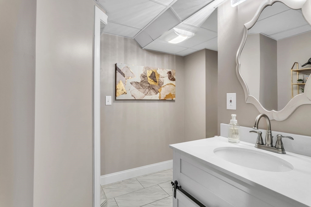 11 Echo Hill Road Wilbraham, MA 01095 - Photo 30 of 42 a bathroom with a sink a mirror and a picture on the wall