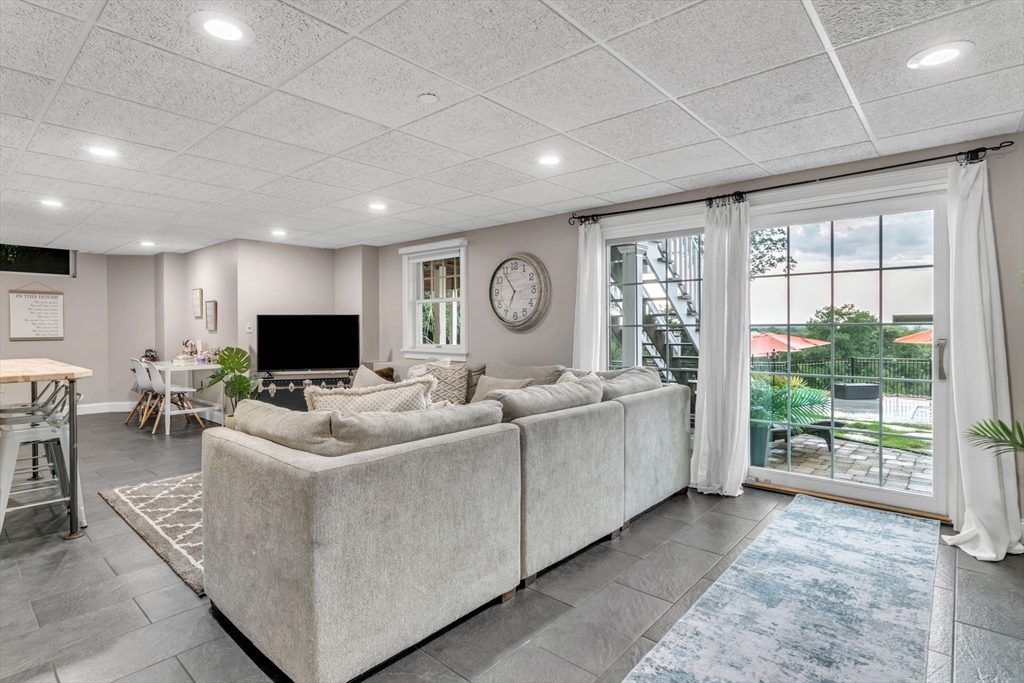 11 Echo Hill Road Wilbraham, MA 01095 - Photo 32 of 42 a living room with furniture a flat screen tv and a large window