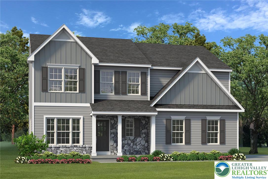 a front view of a house with a yard and potted plants