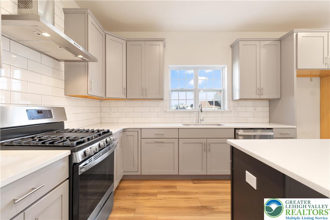 77 Tumble Creek Road, Unit 14 Easton, PA 18042 - Photo 11 of 32 a kitchen with stainless steel appliances granite countertop a stove a sink and a microwave