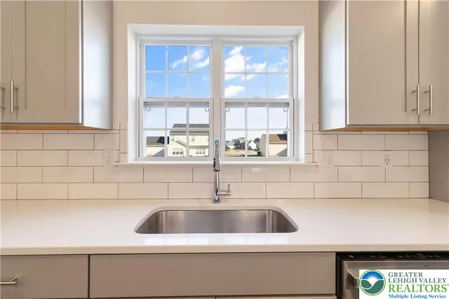 a kitchen with a sink stove top oven and cabinets