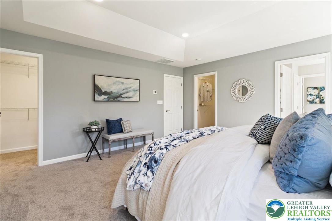 77 Tumble Creek Road, Unit 14 Easton, PA 18042 - Photo 22 of 32 a bedroom with a bed and a painting on the wall