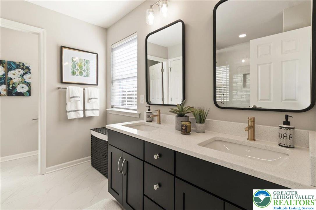 77 Tumble Creek Road, Unit 14 Easton, PA 18042 - Photo 23 of 32 a bathroom with double sink and a mirror