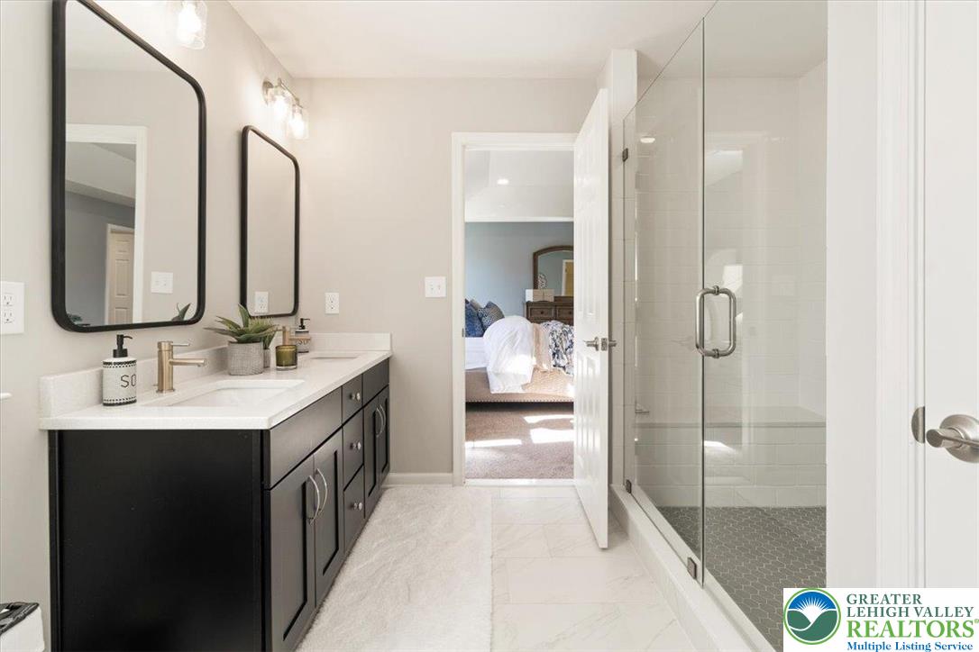 77 Tumble Creek Road, Unit 14 Easton, PA 18042 - Photo 24 of 32 a en suite bathroom with a double vanity sink a mirror and a shower