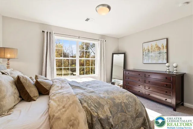 a bedroom with a bed and a desk