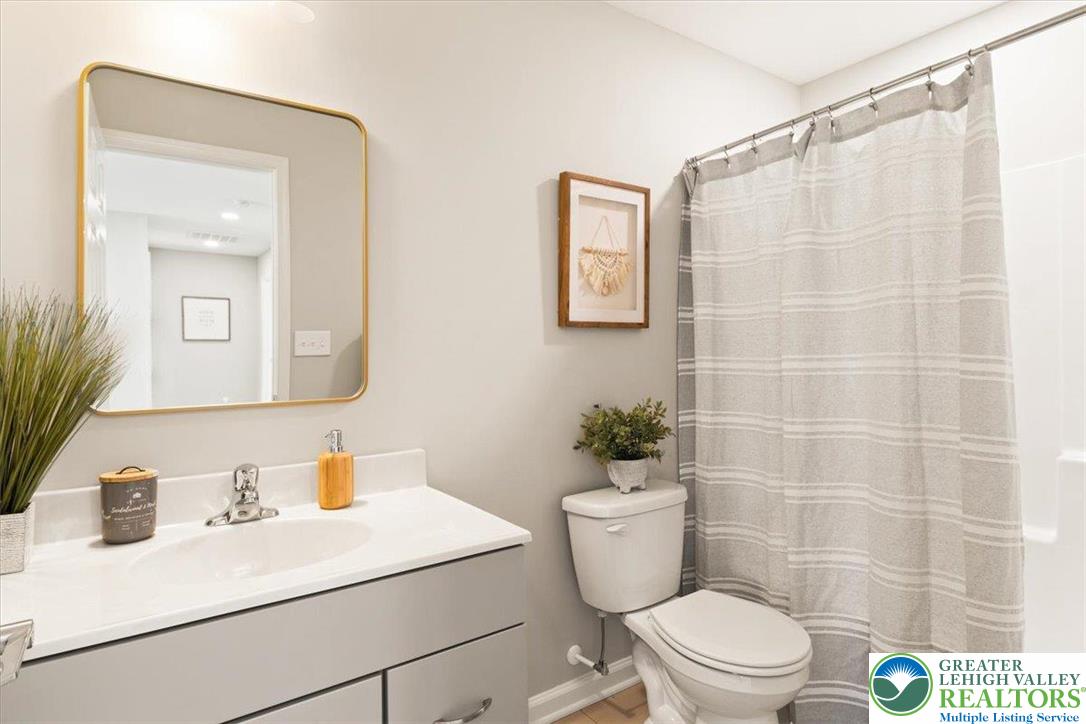 77 Tumble Creek Road, Unit 14 Easton, PA 18042 - Photo 28 of 32 a bathroom with a sink a toilet a mirror and shower