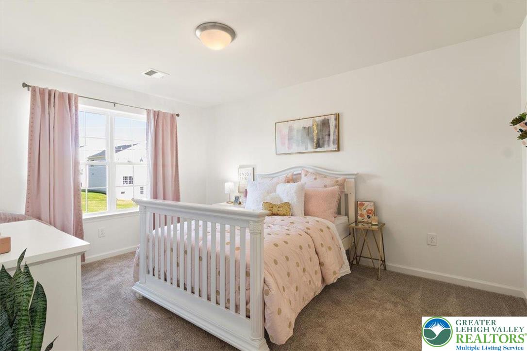 77 Tumble Creek Road, Unit 14 Easton, PA 18042 - Photo 29 of 32 a bedroom with a bed and a window