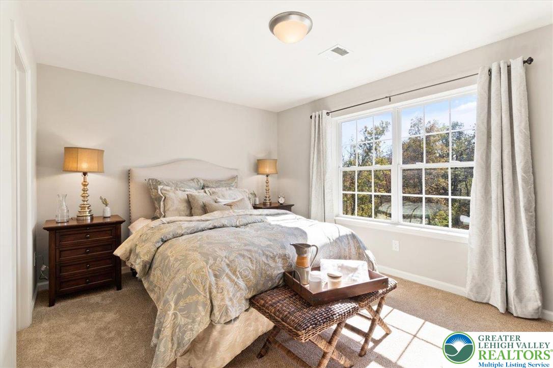 77 Tumble Creek Road, Unit 14 Easton, PA 18042 - Photo 30 of 32 a bedroom with a bed and wooden floor