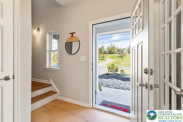 a view of gym equipment with wooden floor and window
