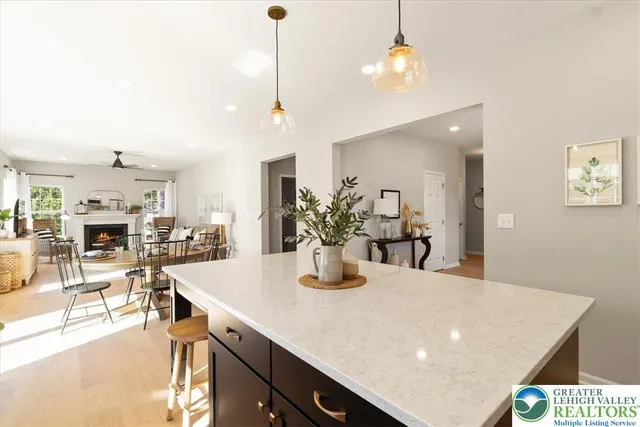 a kitchen with kitchen island a sink a stove a refrigerator and a center island