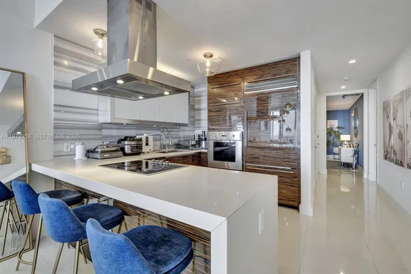 a kitchen with stainless steel appliances granite countertop a sink and cabinets