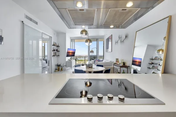 a large kitchen with a table and chairs
