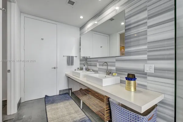 a bathroom with a double vanity sink and a mirror
