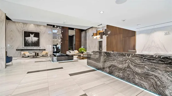 a living room with furniture and potted plant