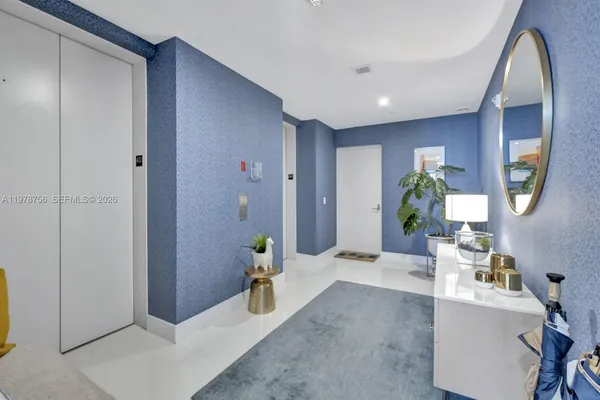 a living room with furniture and a chair