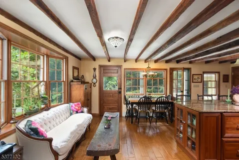 a living room with furniture and a floor to ceiling window