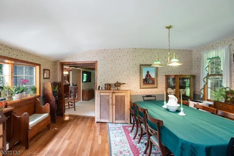 a living room with furniture dining table and a chandelier