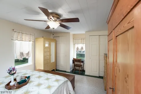 a bedroom with furniture and a large window