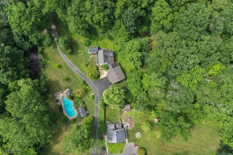 a bird view of a house with a yard and trees