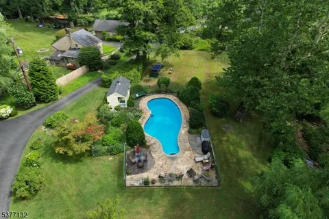 a backyard of a house with a yard and outdoor seating