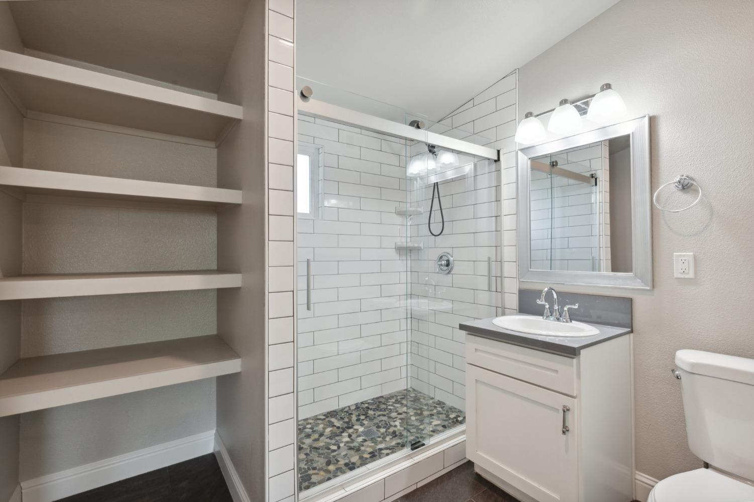 345 Gettysburg Clovis, CA 93612 - Photo 20 of 25 a bathroom with a sink and a mirror