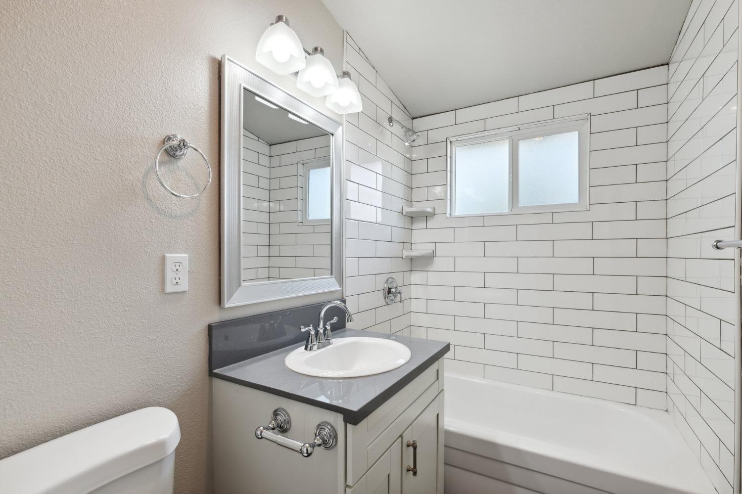 345 Gettysburg Clovis, CA 93612 - Photo 21 of 25 a bathroom with a sink a toilet and shower