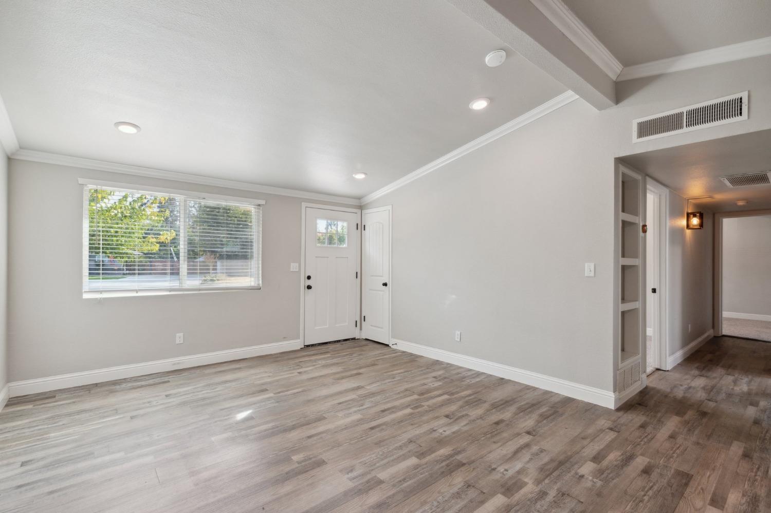 345 Gettysburg Clovis, CA 93612 - Photo 7 of 25 an empty room with wooden floor and windows