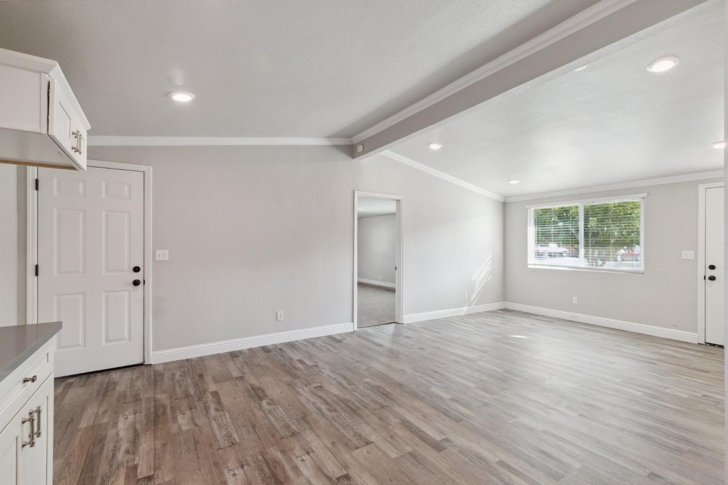345 Gettysburg Clovis, CA 93612 - Photo 10 of 25 an empty room with wooden floor and windows