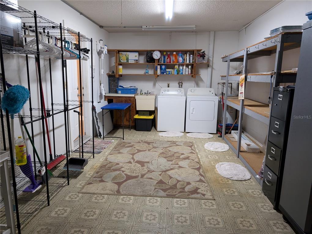 8161 Braddock Circle, Unit 1 Port Richey, FL 34668 - Photo 23 of 27 a utility room with cabinets