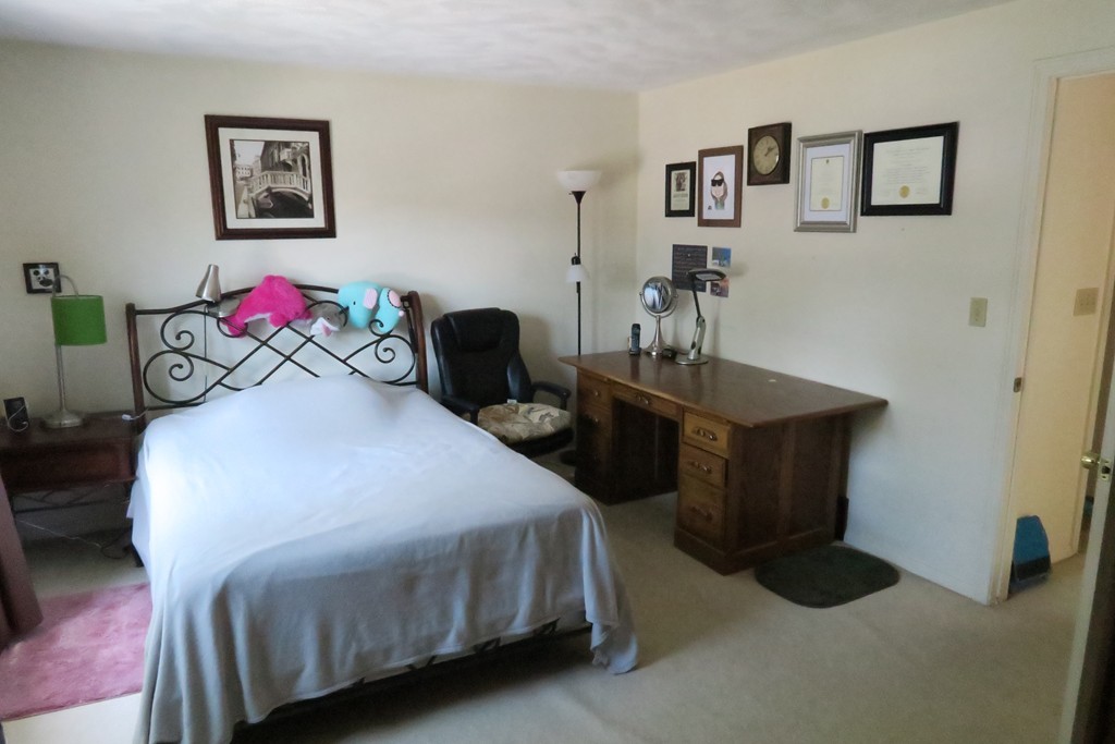 134 Russet Lane, Unit 134 Boxborough, MA 01719 - Photo 13 of 16 a bedroom with a bed and a table