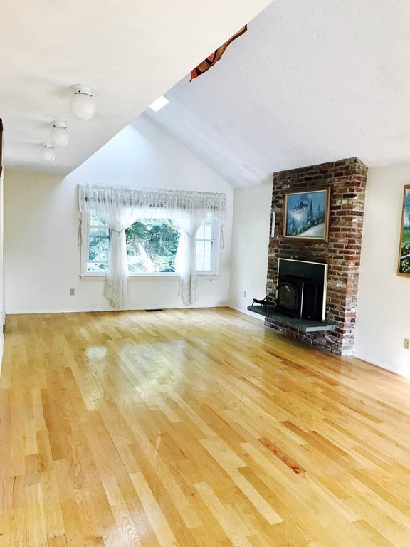 134 Russet Lane, Unit 134 Boxborough, MA 01719 - Photo 9 of 16 a view of empty room with wooden floor and fan