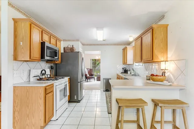 a kitchen with a sink stove and refrigerator