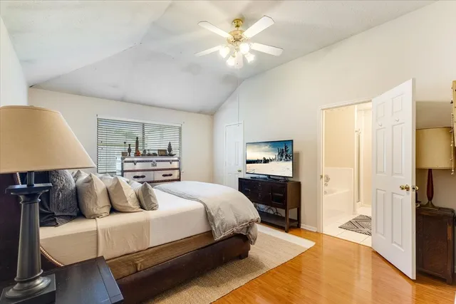 a bedroom with bed and a chandelier