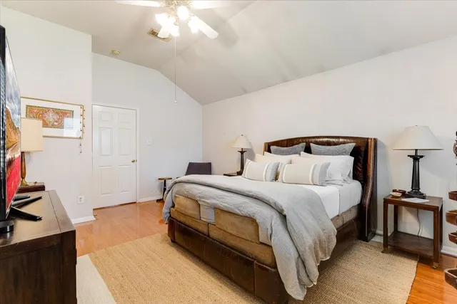 a bedroom with bed and a chandelier