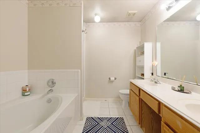 a bathroom with a tub sink and a mirror