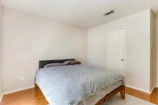 a bedroom with a bed and a night stand