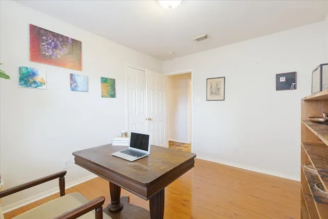 a view of a workspace with furniture and wooden floor