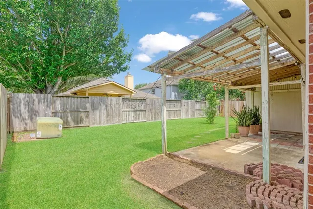 a backyard of a house with table and chairs