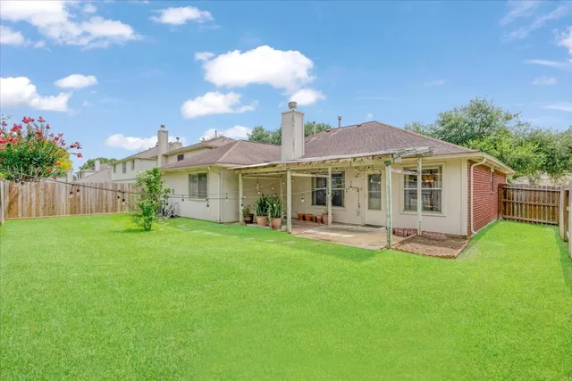 a front view of a house with a garden and yard