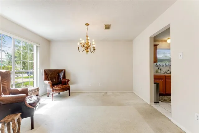 a view of a livingroom with workspace and a window