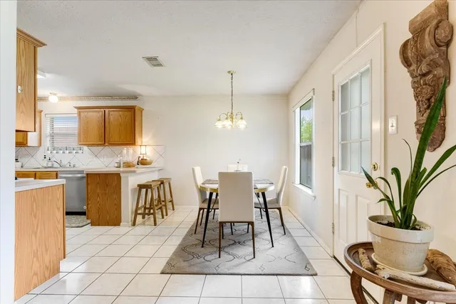 a view of a dining room with furniture and a potted plant