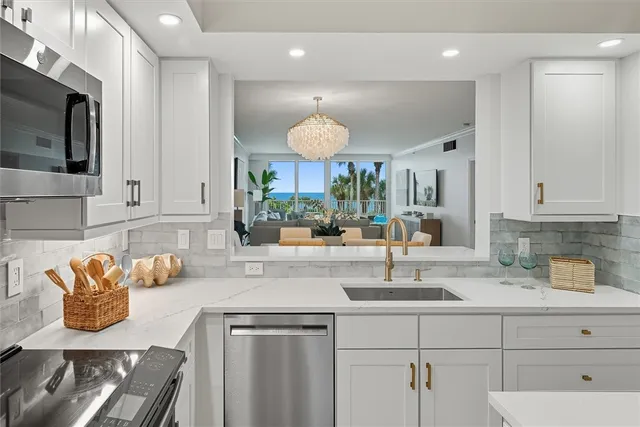 a living room with furniture and large windows